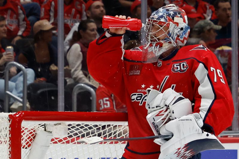 Oct 5, 2024; Washington, District of Columbia, USA; Washington Capitals goaltender Charlie Lindgren (79) squirts his face with water during a stoppage in play against the Boston Bruins in the second period at Capital One Arena. Mandatory Credit: Geoff Burke-Imagn Images