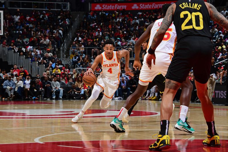 ATLANTA, GA - FEBRUARY 27: Kobe Bufkin #4 of the Atlanta Hawks dribbles the ball during the game against the Utah Jazz on February 27, 2024 at State Farm Arena in Atlanta, Georgia.  NOTE TO USER: User expressly acknowledges and agrees that, by downloading and/or using this Photograph, user is consenting to the terms and conditions of the Getty Images License Agreement. Mandatory Copyright Notice: Copyright 2024 NBAE (Photo by Scott Cunningham/NBAE via Getty Images)