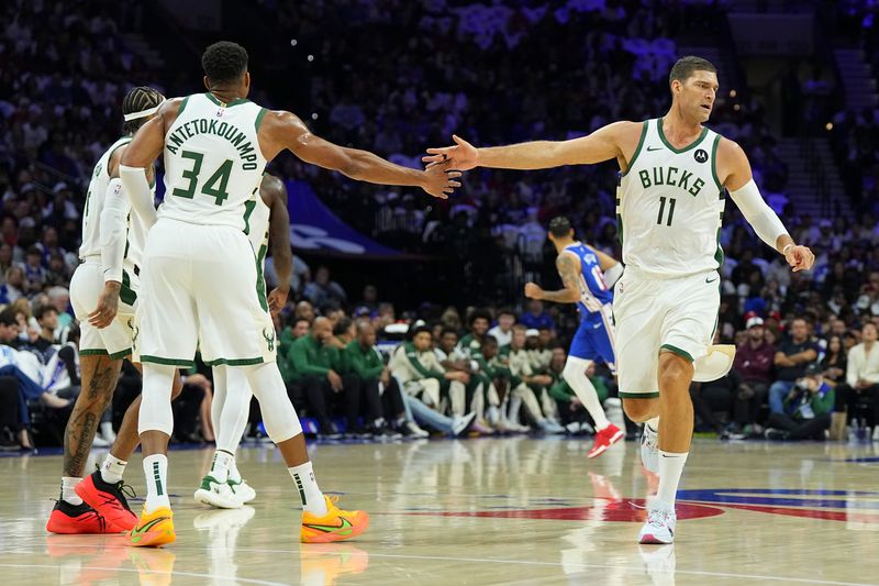 PHILADELPHIA, PENNSYLVANIA - OCTOBER 23: Giannis Antetokounmpo #34 of the Milwaukee Bucks celebrates with Brook Lopez #11 against the Philadelphia 76ers in the first half at the Wells Fargo Center on October 23, 2024 in Philadelphia, Pennsylvania. NOTE TO USER: User expressly acknowledges and agrees that, by downloading and/or using this photograph, user is consenting to the terms and conditions of the Getty Images License Agreement. (Photo by Mitchell Leff/Getty Images)