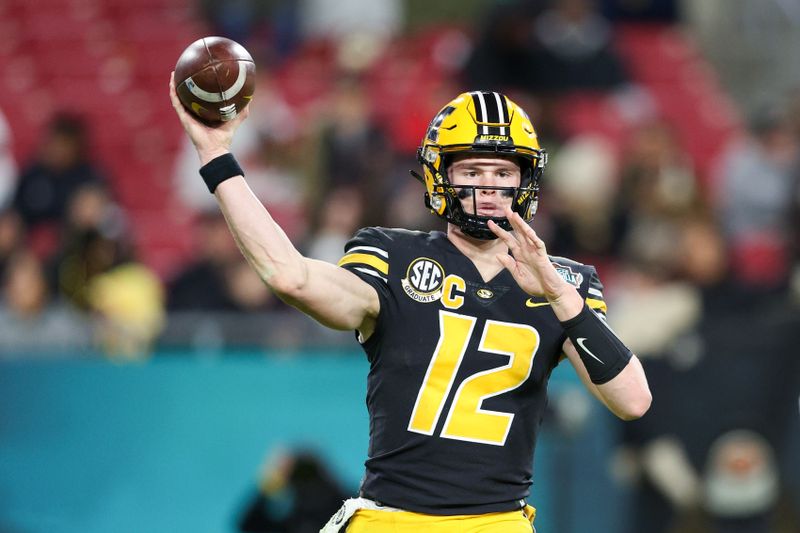 Dec 23, 2022; Tampa, Florida, USA; Missouri Tigers quarterback Brady Cook (12) throws a pass against the Wake Forest Demon Deacons in the third quarter in the 2022 Gasparilla Bowl at Raymond James Stadium. Mandatory Credit: Nathan Ray Seebeck-USA TODAY Sports