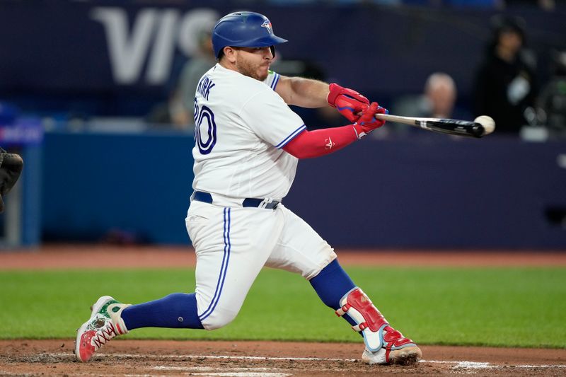 Sep 8, 2023; Toronto, Ontario, CAN; Toronto Blue Jays catcher Alejandro Kirk (30) makes contact with a Kansas City Royals pitch during the fifth inning at Rogers Centre. Mandatory Credit: John E. Sokolowski-USA TODAY Sports