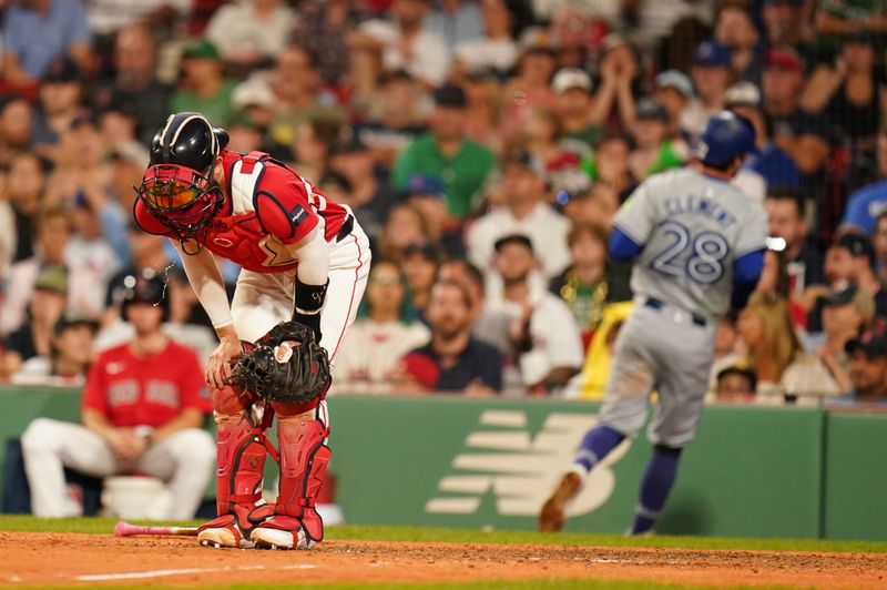 Aug 26, 2024; Boston, Massachusetts, USA; Boston Red Sox catcher Connor Wong (12) reacts after Toronto Blue Jays third baseman Ernie Clement (28) scores in the ninth inning at Fenway Park. Mandatory Credit: David Butler II-USA TODAY Sports