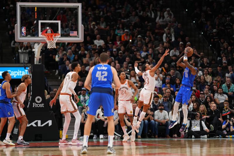 SAN ANTONIO, TX - MARCH 19: Kyrie Irving #11 of the Dallas Mavericks shoots the ball during the game against the San Antonio Spurs on March 19, 2024 at the Frost Bank Center in San Antonio, Texas. NOTE TO USER: User expressly acknowledges and agrees that, by downloading and or using this photograph, user is consenting to the terms and conditions of the Getty Images License Agreement. Mandatory Copyright Notice: Copyright 2024 NBAE (Photos by Darren Carroll/NBAE via Getty Images)