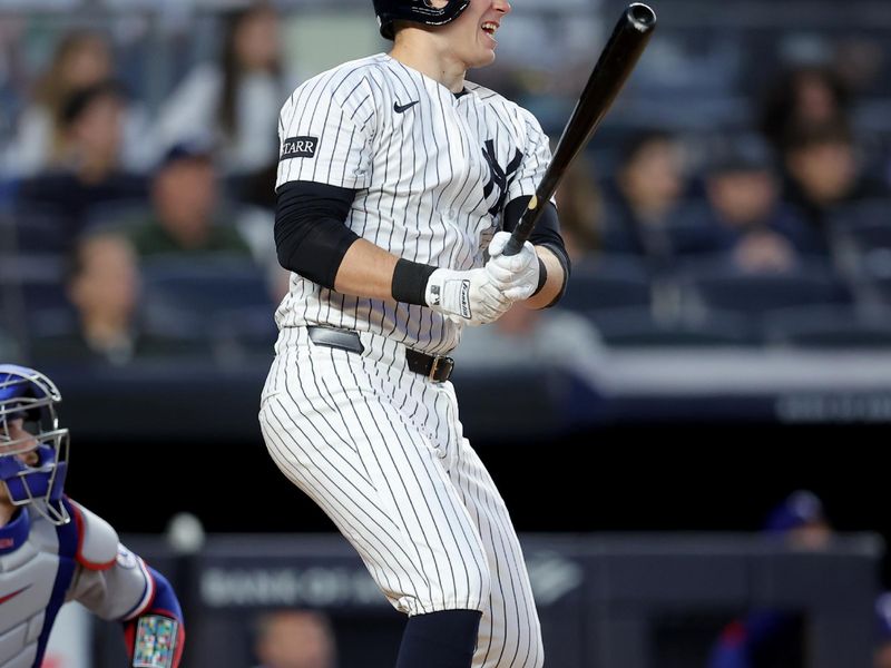 May 20, 2025; Bronx, New York, USA; New York Yankees designated hitter Ben Rice (22) follows through on an RBI sacrifice fly against the Texas Rangers during the fourth inning at Yankee Stadium. Mandatory Credit: Brad Penner-Imagn Images