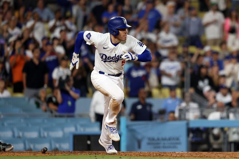 Jul 2, 2024; Los Angeles, California, USA;  Los Angeles Dodgers first baseman Freddie Freeman (5) hits an RBI double during the ninth inning against the Arizona Diamondbacks at Dodger Stadium. Mandatory Credit: Kiyoshi Mio-USA TODAY Sports