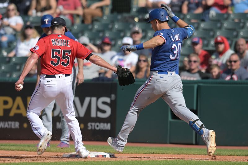 Sep 17, 2023; Cleveland, Ohio, USA; Cleveland Guardians relief pitcher Matt Moore (55) forces out Texas Rangers first baseman Nathaniel Lowe (30) during the seventh inning at Progressive Field. Mandatory Credit: Ken Blaze-USA TODAY Sports