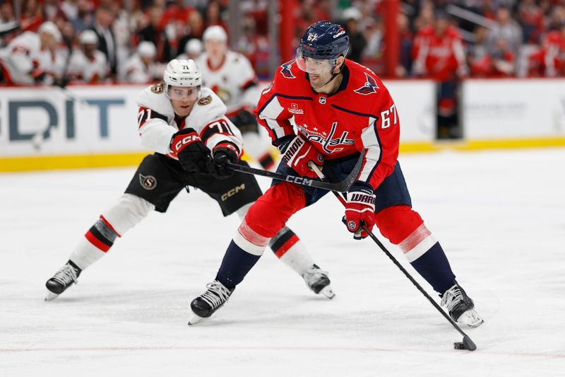 Apr 7, 2024; Washington, District of Columbia, USA; Washington Capitals left wing Max Pacioretty (67) skates with the puck as Ottawa Senators center Ridly Greig (71) defends in the third period at Capital One Arena. Mandatory Credit: Geoff Burke-USA TODAY Sports