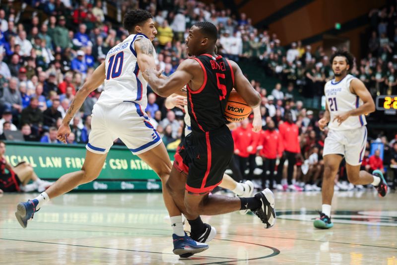 Jan 30, 2024; Fort Collins, Colorado, USA; San Diego State Aztecs guard Lamont Butler (5) is tripped up by Colorado State Rams guard Nique Clifford (10) in the first half at Moby Arena. Mandatory Credit: Chet Strange-USA TODAY Sports