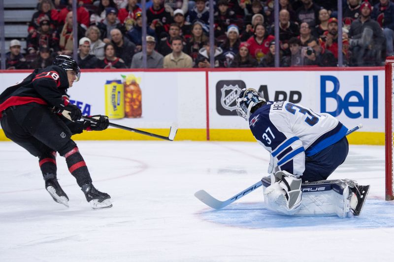 Jan 3, 2026; Ottawa, Ontario, CAN; Winnipeg Jets goalie Connor Hellebuyck (37) makes a save on a shot from Ottawa Senators center Tim Stutzle (18) in the first period at the Canadian Tire Centre. Mandatory Credit: Marc DesRosiers-IMAGN Images