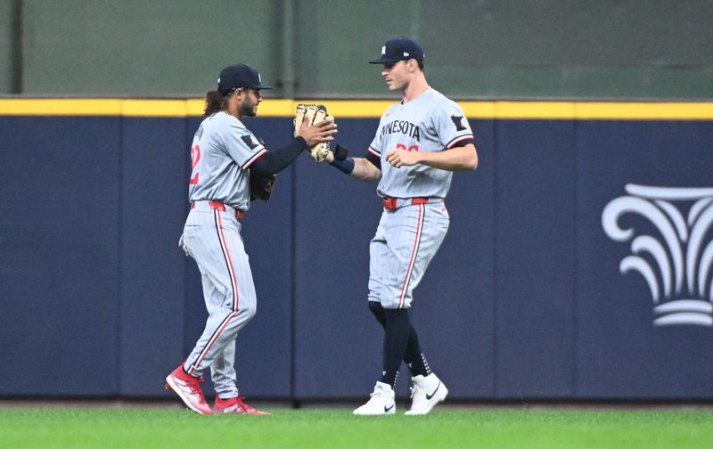 Apr 3, 2024; Milwaukee, Wisconsin, USA; Minnesota Twins center fielder Austin Martin (82) and right fielder Max Kepler (26) celebrate a 7-3 win over the Milwaukee Brewers at American Family Field. Mandatory Credit: Michael McLoone-USA TODAY Sports