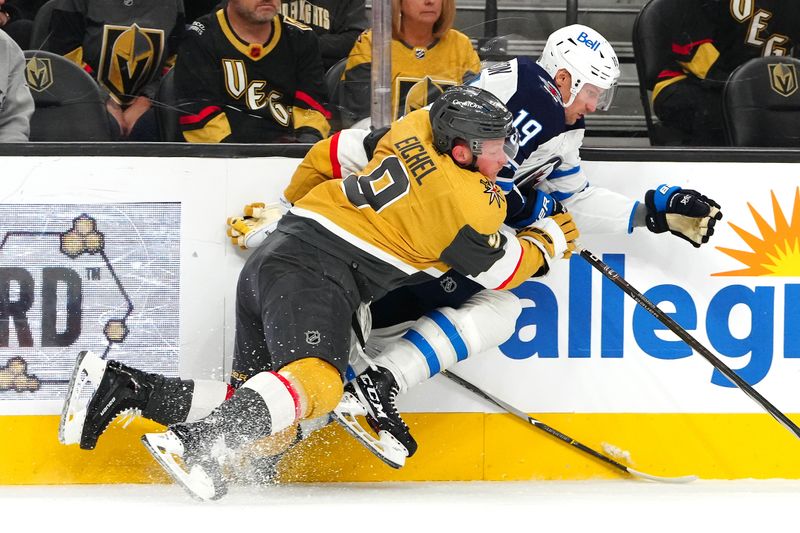 Nov 2, 2023; Las Vegas, Nevada, USA; Vegas Golden Knights center Jack Eichel (9) falls while attempting to check Winnipeg Jets center David Gustafsson (19) during the first period at T-Mobile Arena. Mandatory Credit: Stephen R. Sylvanie-USA TODAY Sports