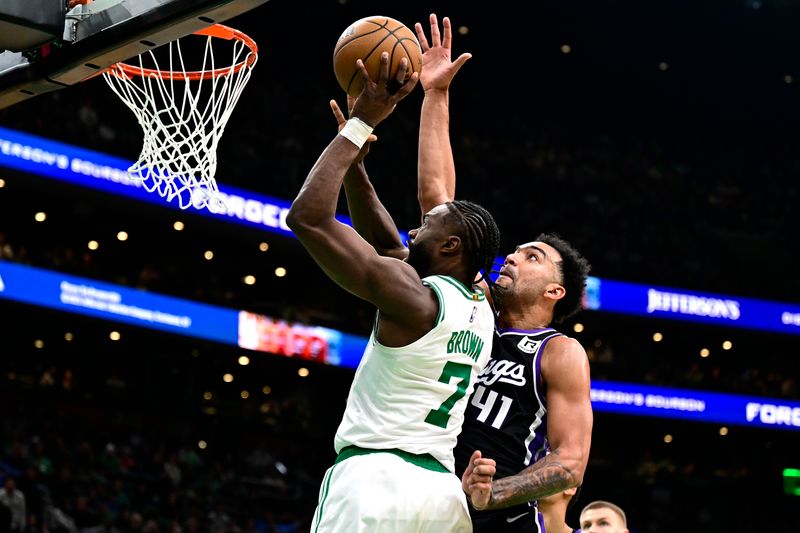 BOSTON, MASSACHUSETTS - JANUARY 10: Jaylen Brown #7 of the Boston Celtics shoots a lay up as he is defended by Trey Lyles #41 of the Sacramento Kings during the first half of a game at TD Garden on January 10, 2025 in Boston, Massachusetts.  NOTE TO USER: User expressly acknowledges and agrees that, by downloading and or using this photograph, User is consenting to the terms and conditions of the Getty Images License Agreement. (Photo by Billie Weiss/Getty Images)