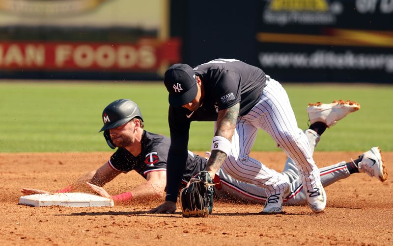 Feb 26, 2024; Tampa, Florida, USA; Minnesota Twins second baseman Edouard Julien (47) steals second base as New York Yankees second baseman Gleyber Torres (25) attempted to tag him out at George M. Steinbrenner Field. Mandatory Credit: Kim Klement Neitzel-USA TODAY Sports