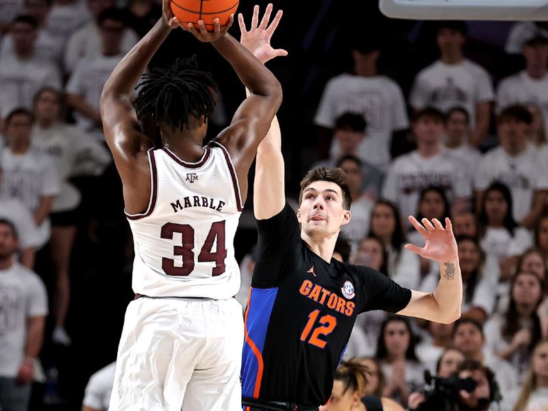 Jan 18, 2023; College Station, Texas, USA; Texas A&M Aggies forward Julius Marble (34) takes an outside shot while Florida Gators forward Colin Castleton (12) defends during the first half at Reed Arena. Mandatory Credit: Erik Williams-USA TODAY Sports
