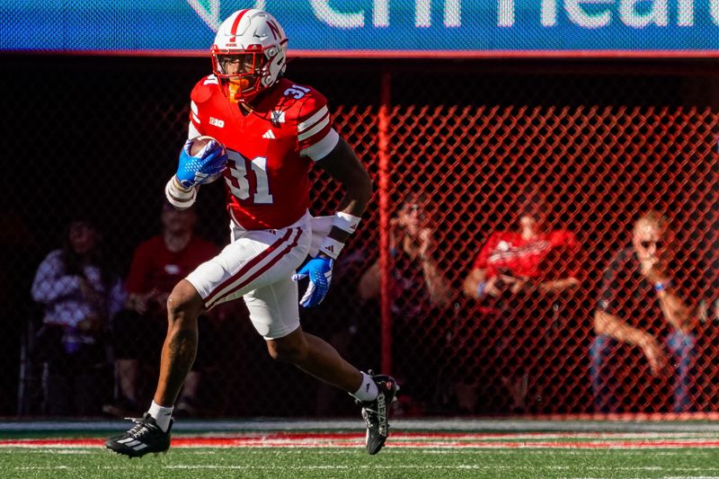 Oct 21, 2023; Lincoln, Nebraska, USA; Nebraska Cornhuskers defensive back Tommi Hill (31) returns a kickoff during the second quarter against the Northwestern Wildcats at Memorial Stadium. Mandatory Credit: Dylan Widger-USA TODAY Sports