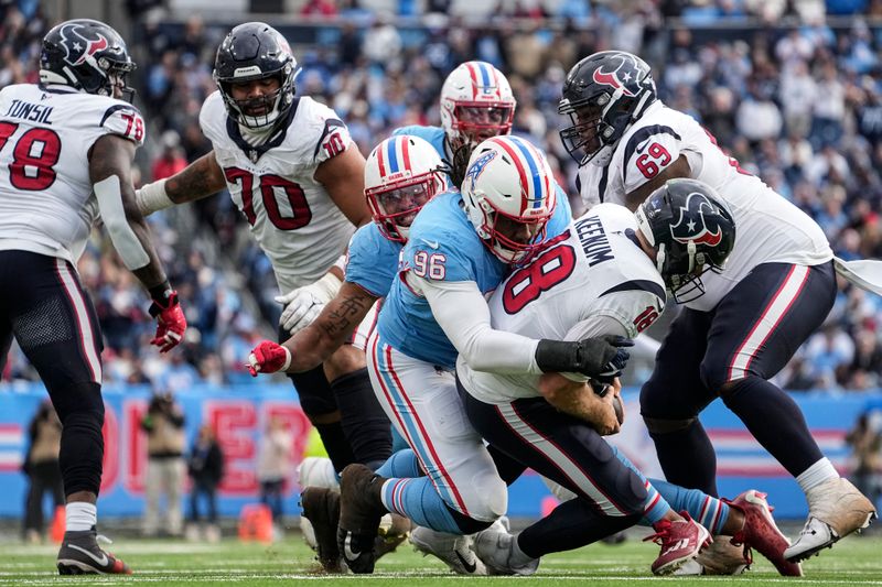 Tennessee Titans defensive end Denico Autry (96) sacks Houston Texans quarterback Case Keenum (18) during the second half of an NFL football game, Sunday, Dec. 17, 2023, in Nashville, Tenn. (AP Photo/George Walker IV)