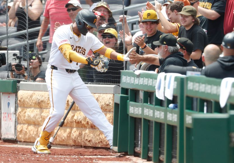Jul 8, 2024; Pittsburgh, Pennsylvania, USA;  Pittsburgh Pirates right fielder Joshua Palacios (77) celebrates as he returns to the dugout after hitting a solo home run against the New York Mets during the sixth inning at PNC Park. The Pirates won 8-2. Mandatory Credit: Charles LeClaire-USA TODAY Sports