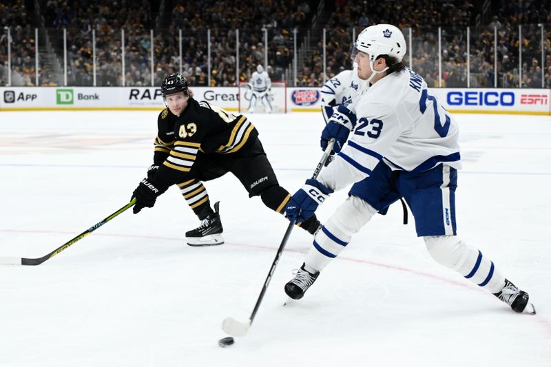 Apr 22, 2024; Boston, Massachusetts, USA; Toronto Maple Leafs left wing Matthew Knies (23) passes the puck against Boston Bruins center Danton Heinen (43) during the second period in game two of the first round of the 2024 Stanley Cup Playoffs at TD Garden. Mandatory Credit: Brian Fluharty-USA TODAY Sports