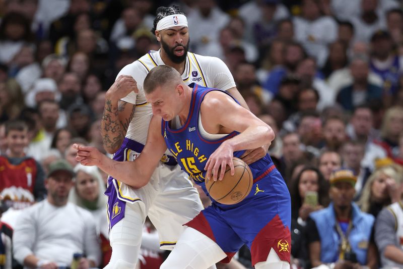 DENVER, COLORADO - APRIL 20: Nikola Jokic #15 of the Denver Nuggets drives against Anthony Davis #3 of the Los Angeles Lakers in the first quarter during game one of the Western Conference First Round Playoffs at Ball Arena on April 20, 2024 in Denver, Colorado.  NOTE TO USER: User expressly acknowledges and agrees that, by downloading and or using this photograph, User is consenting to the terms and conditions of the Getty Images License Agreement. (Photo by Matthew Stockman/Getty Images)