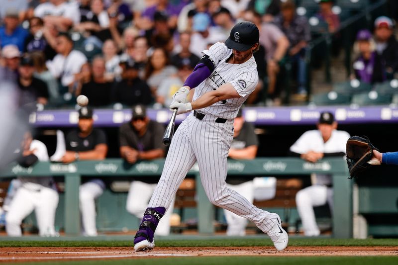 Jun 18, 2024; Denver, Colorado, USA; Colorado Rockies third baseman Ryan McMahon (24) hits a two RBI double in the first inning against the Los Angeles Dodgers at Coors Field. Mandatory Credit: Isaiah J. Downing-USA TODAY Sports