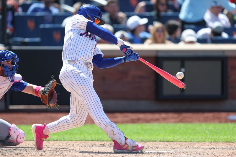 May 11, 2025; New York City, New York, USA; New York Mets shortstop Francisco Lindor (12) hits a solo home run during the eighth inning against the Chicago Cubs at Citi Field. Mandatory Credit: Vincent Carchietta-Imagn Images