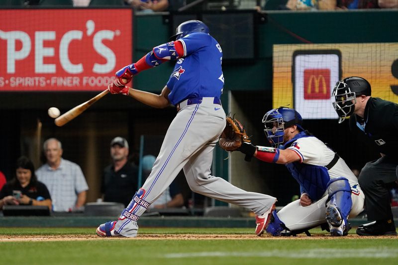 Sep 19, 2024; Arlington, Texas, USA; Toronto Blue Jays first baseman Vladimir Guerrero Jr. (27) hits a solo home run during the ninth inning against the Texas Rangers at Globe Life Field. Mandatory Credit: Raymond Carlin III-Imagn Images