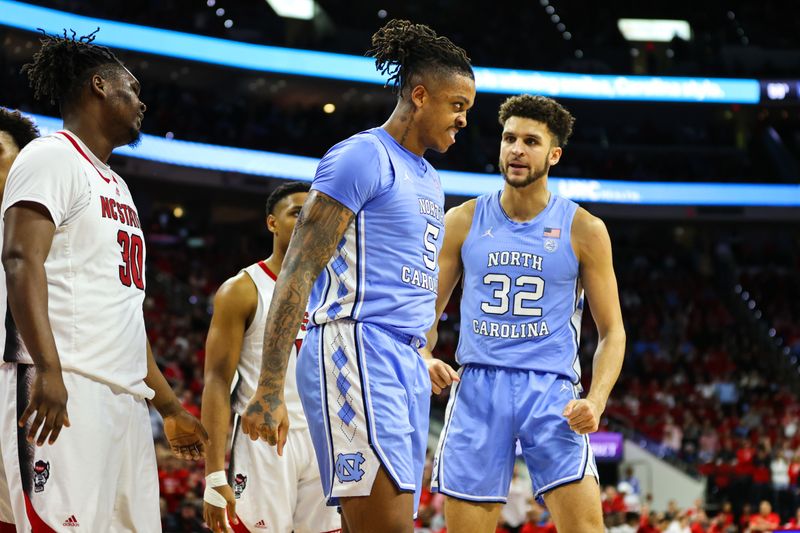 Feb 19, 2023; Raleigh, North Carolina, USA;  North Carolina Tar Heels forward Armando Bacot (5) and forward Pete Nance (32) react during the second half of the game against North Carolina State Wolfpack at PNC Arena. Mandatory Credit: Jaylynn Nash-USA TODAY Sports