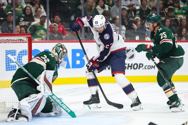 Oct 10, 2024; Saint Paul, Minnesota, USA; Columbus Blue Jackets center Sean Monahan (23) looks to shoot as Minnesota Wild goaltender Filip Gustavsson (32) and defenseman Jonas Brodin (25) defend during the first period at Xcel Energy Center. Mandatory Credit: Matt Krohn-Imagn Images