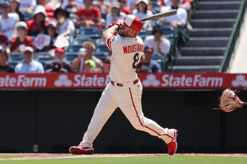 Sep 10, 2023; Anaheim, California, USA; Los Angeles Angels first baseman Mike Moustakas (8) follows through on a sacrifice fly ball to score Los Angeles Angels right fielder Randal Grichuk (15) during the first inning of a game against the Cleveland Guardians at Angel Stadium. Mandatory Credit: Jessica Alcheh-USA TODAY Sports