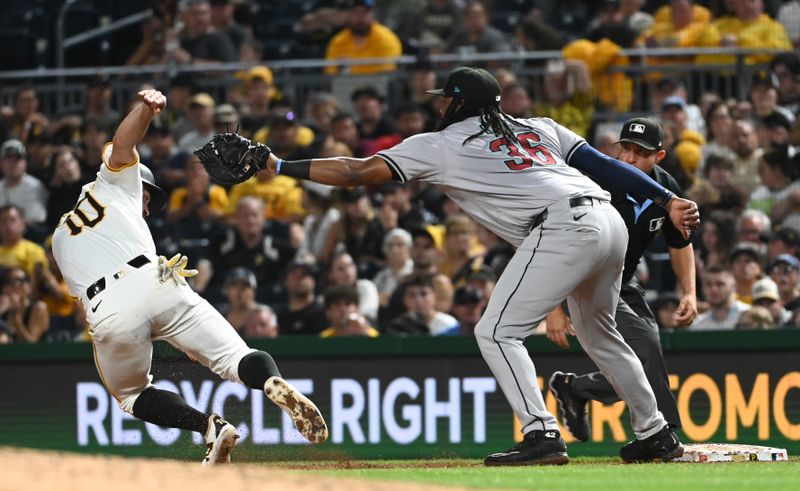 Aug 3, 2024; Pittsburgh, Pennsylvania, USA;  Pittsburgh Pirates base runner Bryan Reynolds (10) is caught in a run down with Arizona Diamondbacks first baseman Josh Bell (36) in the eighth inning  at PNC Park. Mandatory Credit: Philip G. Pavely-USA TODAY Sports