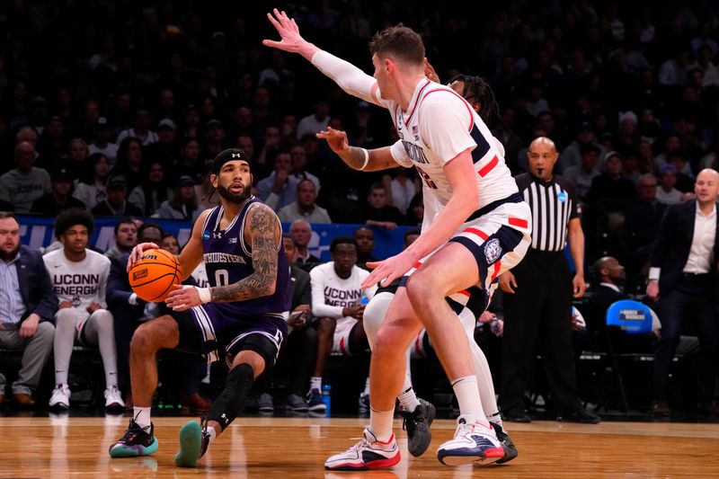 Mar 24, 2024; Brooklyn, NY, USA; Northwestern Wildcats guard Boo Buie (0) dribbles the ball against the Connecticut Huskies in the second round of the 2024 NCAA Tournament at the Barclays Center. Mandatory Credit: Robert Deutsch-USA TODAY Sports