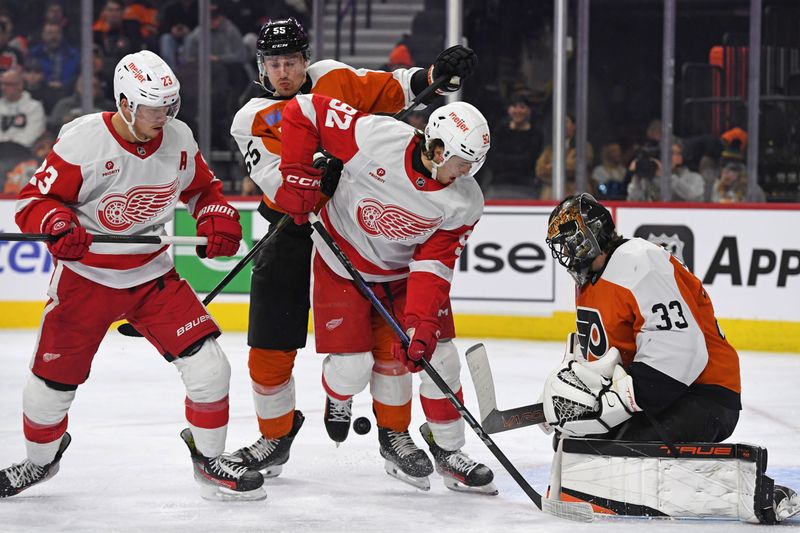 Jan 21, 2025; Philadelphia, Pennsylvania, USA; Philadelphia Flyers defenseman Rasmus Ristolainen (55) and Detroit Red Wings center Marco Kasper (92) battle the puck in front of Philadelphia Flyers goaltender Samuel Ersson (33) during the second period at Wells Fargo Center. Mandatory Credit: Eric Hartline-Imagn Images Jan 21, 2025; Philadelphia, Pennsylvania, USA; Philadelphia Flyers defenseman Rasmus Ristolainen (55) and Detroit Red Wings center Marco Kasper (92) battle the puck in front of Philadelphia Flyers goaltender Samuel Ersson (33) during the second period at Wells Fargo Center. Mandatory Credit: Eric Hartline-Imagn Images