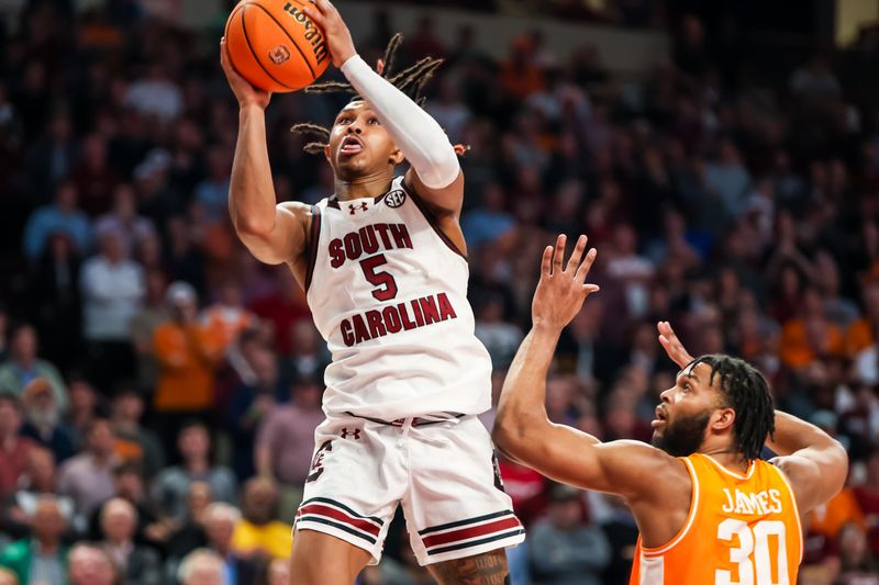 Mar 6, 2024; Columbia, South Carolina, USA; South Carolina Gamecocks guard Meechie Johnson (5) drives past Tennessee Volunteers guard Josiah-Jordan James (30) in the second half at Colonial Life Arena. Mandatory Credit: Jeff Blake-USA TODAY Sports