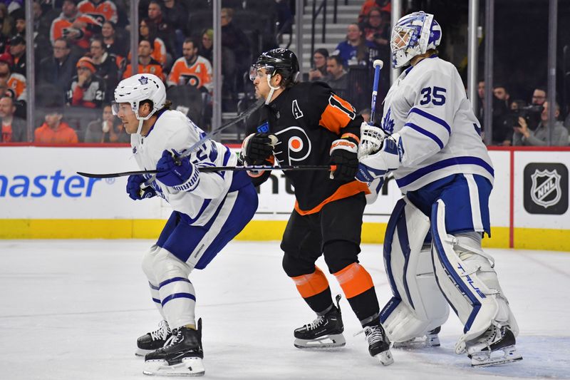 Mar 19, 2024; Philadelphia, Pennsylvania, USA; Philadelphia Flyers right wing Travis Konecny (11) battles with Toronto Maple Leafs defenseman Jake McCabe (22) in front of goaltender Ilya Samsonov (35) during the first period at Wells Fargo Center. Mandatory Credit: Eric Hartline-USA TODAY Sports