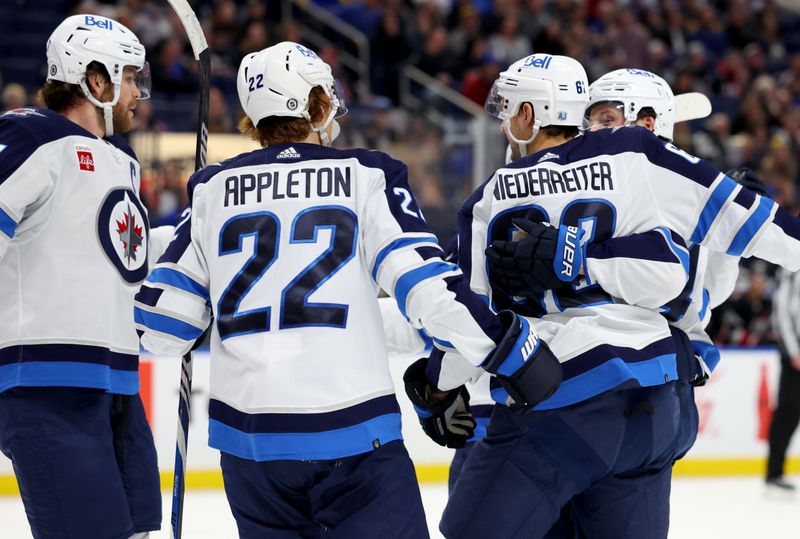 Mar 3, 2024; Buffalo, New York, USA;  Winnipeg Jets right wing Nino Niederreiter (62) celebrates his goal with teammates during the first period against the Buffalo Sabres at KeyBank Center. Mandatory Credit: Timothy T. Ludwig-USA TODAY Sports