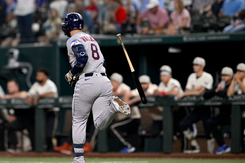 May 16, 2025; Arlington, Texas, USA; Houston Astros first baseman Christian Walker (8) flips his bat after he hits a three run home run against the Texas Rangers during the seventh inning at Globe Life Field. Mandatory Credit: Jerome Miron-Imagn Images