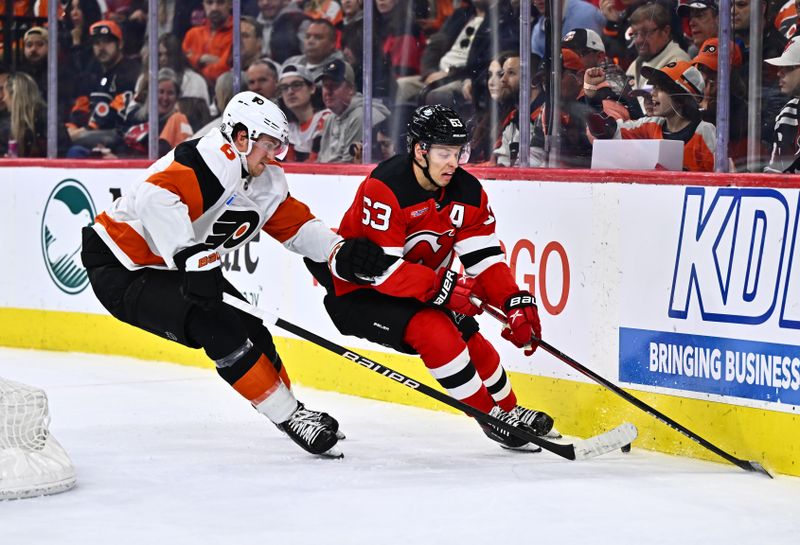 Apr 13, 2024; Philadelphia, Pennsylvania, USA; New Jersey Devils left wing Jesper Bratt (63) and Philadelphia Flyers defenseman Travis Sanheim (6) battle for the puck in the second period at Wells Fargo Center. Mandatory Credit: Kyle Ross-USA TODAY Sports