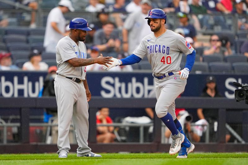 Jul 8, 2023; Bronx, New York, USA; Chicago Cubs third base coach Willie Harris (33) congratulates designated hitter Mike Tauchman (40) for hitting a two run home run against the New York Yankees during the eighth inning at Yankee Stadium. Mandatory Credit: Gregory Fisher-USA TODAY Sports