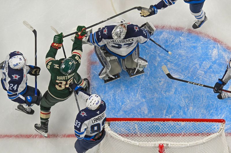 Sep 27, 2024; Saint Paul, Minnesota, USA;  Minnesota Wild forward Ryan Hartman (38) has a goal disallowed for playing it with a high-stick against the Winnipeg Jets during the first period at Xcel Energy Center. Mandatory Credit: Nick Wosika-Imagn Images

