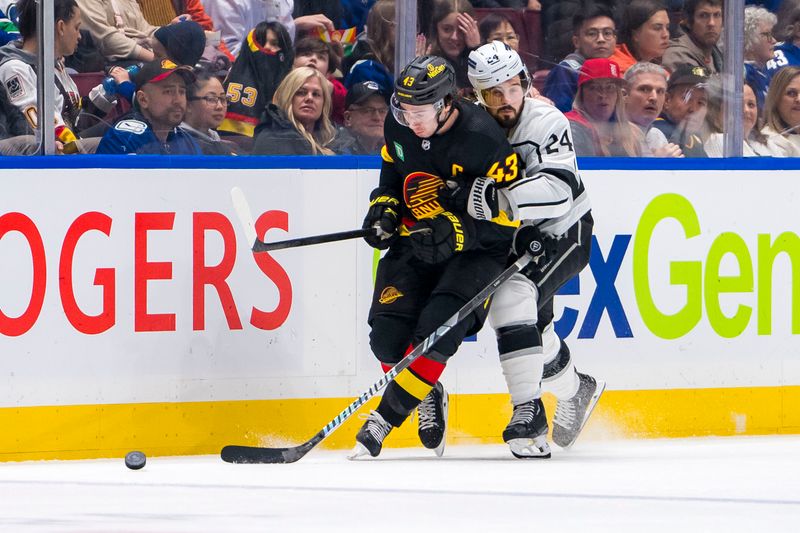 Mar 25, 2024; Vancouver, British Columbia, CAN;  Los Angeles Kings forward Phillip Danault (24) checks Vancouver Canucks defenseman Quinn Hughes (43) in the second period at Rogers Arena. Mandatory Credit: Bob Frid-USA TODAY Sports