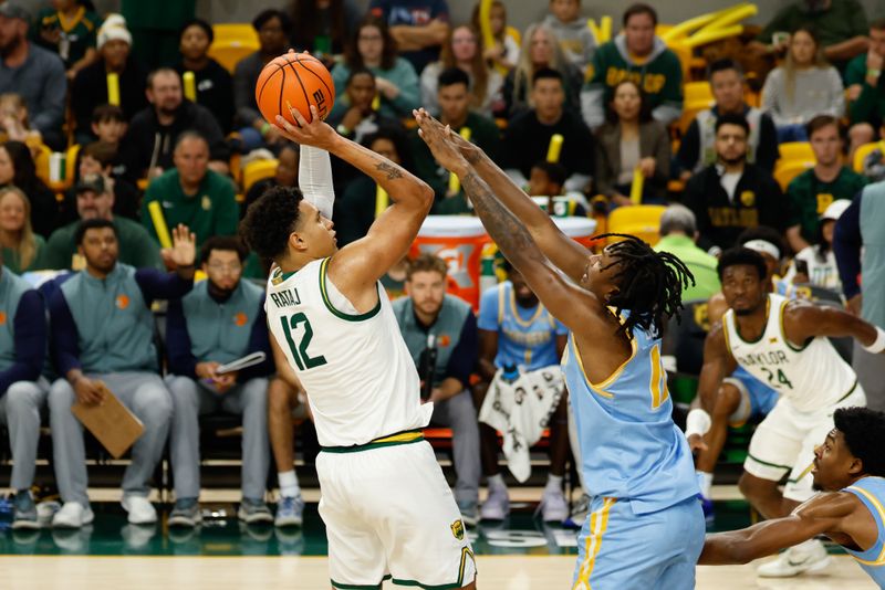 Dec 21, 2025; Waco, Texas, USA; Baylor Bears guard Michael Rataj (12) scores a basket against Southern University Jaguars guard Michael Jacobs (10) during the first half at Paul and Alejandra Foster Pavilion. Mandatory Credit: Chris Jones-Imagn Images