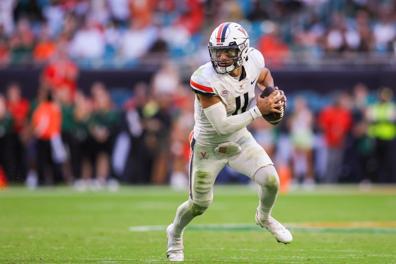 Oct 28, 2023; Miami Gardens, Florida, USA; Virginia Cavaliers quarterback Tony Muskett (11) runs with the ball against the Miami Hurricanes during the fourth quarter at Hard Rock Stadium. Mandatory Credit: Sam Navarro-USA TODAY Sports