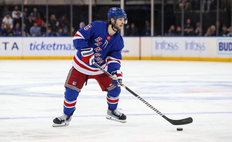 Nov 25, 2024; New York, New York, USA; New York Rangers defenseman Zac Jones (6) looks to pass against the St. Louis Blues during the second period at Madison Square Garden. Mandatory Credit: Danny Wild-Imagn Images