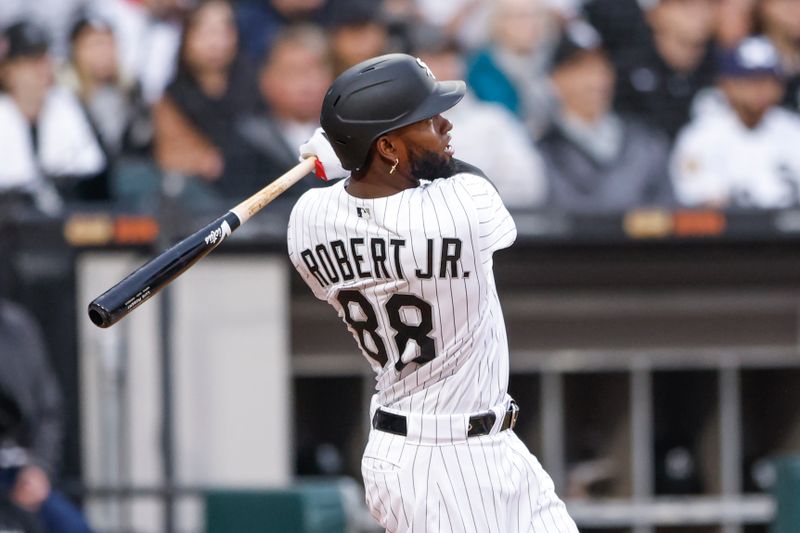 May 13, 2023; Chicago, Illinois, USA; Chicago White Sox center fielder Luis Robert Jr. (88) hits a solo home run against the Houston Astros during the fourth inning at Guaranteed Rate Field. Mandatory Credit: Kamil Krzaczynski-USA TODAY Sports