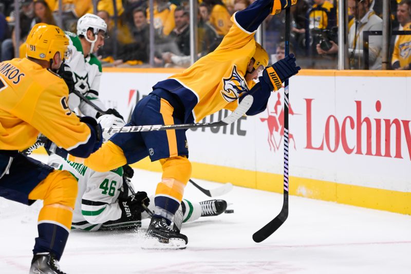 Oct 10, 2024; Nashville, Tennessee, USA; Dallas Stars defenseman Ilya Lyubushkin (46) and Nashville Predators center Gustav Nyquist (14) fight for the puck during the first period at Bridgestone Arena. Mandatory Credit: Steve Roberts-Imagn Images