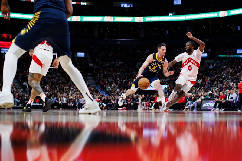 TORONTO, CANADA - APRIL 9: T.J. McConnell #9 of the Indiana Pacers drives to the net against Javon Freeman-Liberty #0 of the Toronto Raptors during second half of their NBA game at Scotiabank Arena on April 9, 2024 in Toronto, Canada. NOTE TO USER: User expressly acknowledges and agrees that, by downloading and or using this photograph, User is consenting to the terms and conditions of the Getty Images License Agreement. (Photo by Cole Burston/Getty Images)