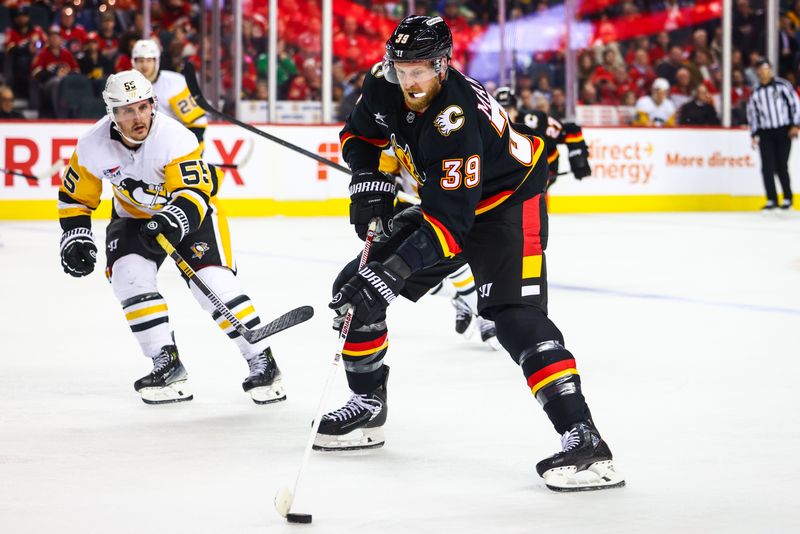 Oct 22, 2024; Calgary, Alberta, CAN; Calgary Flames right wing Anthony Mantha (39) controls the puck against the Pittsburgh Penguins during the second period at Scotiabank Saddledome. Mandatory Credit: Sergei Belski-Imagn Images