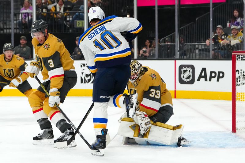 Oct 11, 2024; Las Vegas, Nevada, USA; Vegas Golden Knights goaltender Adin Hill (33) makes a save as St. Louis Blues center Brayden Schenn (10) attempts to deflect the puck during the first period at T-Mobile Arena. Mandatory Credit: Stephen R. Sylvanie-Imagn Images