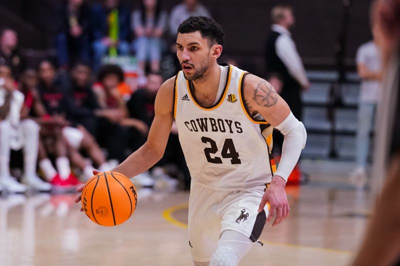 Feb 8, 2023; Laramie, Wyoming, USA; Wyoming Cowboys guard Hunter Maldonado (24) dribbles agains the UNLV Runnin' Rebels during the second half at Arena-Auditorium. Mandatory Credit: Troy Babbitt-USA TODAY Sports