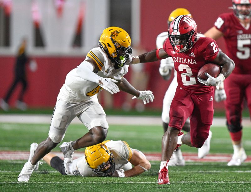 Sep 10, 2022; Bloomington, Indiana, USA;  Indiana Hoosiers running back Shaun Shivers (2) stiff arms Idaho Vandals defensive back Murvin Kenion III (0) during the second half at Memorial Stadium. The Hoosiers won 35-22.  Mandatory Credit: Marc Lebryk-USA TODAY Sports